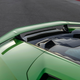 The rear decklid and spoiler of a green Lamborghini Huracan Tecnica.